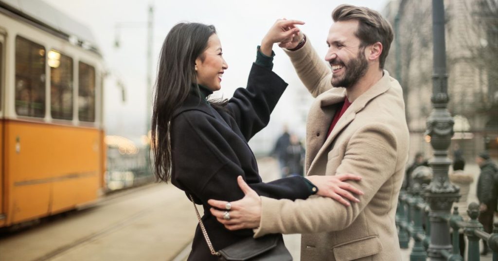 Couple outside dancing together and smiling