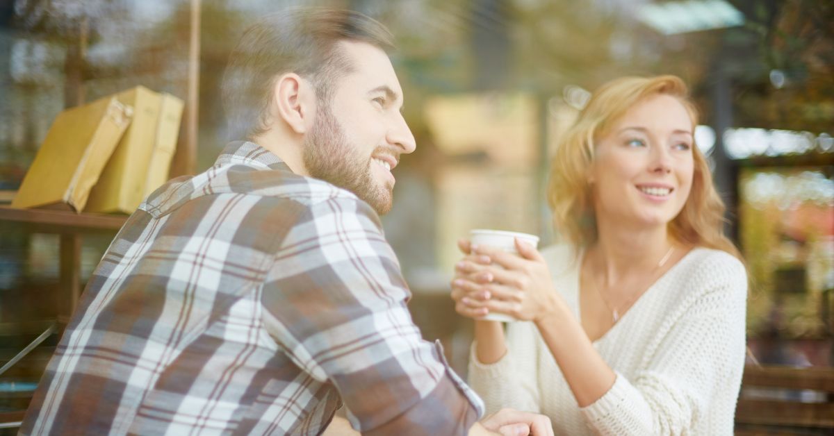 Couple sitting in coffee shop looking out the window