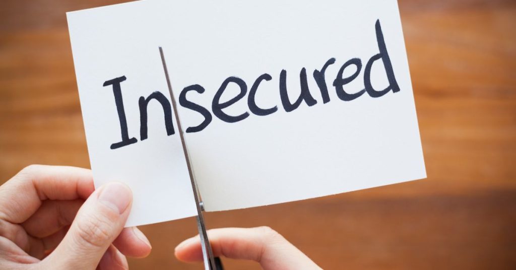 Paper that says "Insecured" being cut to only say "Secured"