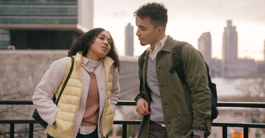 Couple talking with city in background