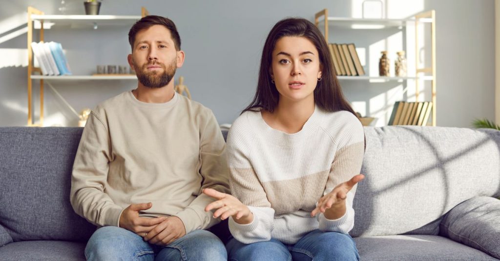 Couple sitting on couch having a discussion with the image viewer