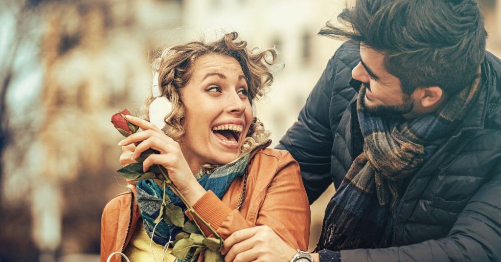 how to be a better listener on a date | Man surprising woman with a rose