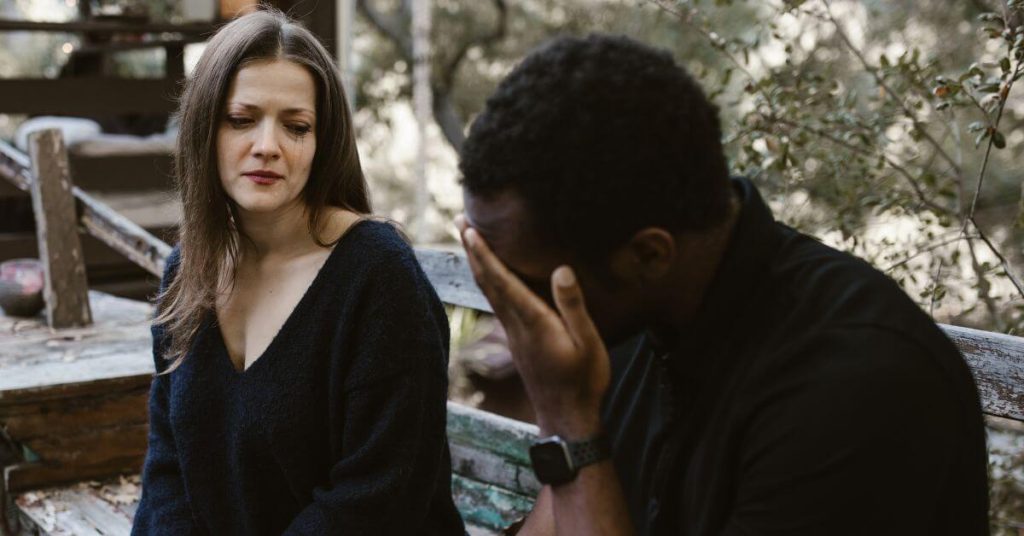 breaking up the grown-up way | Couple sitting next to each other and crying