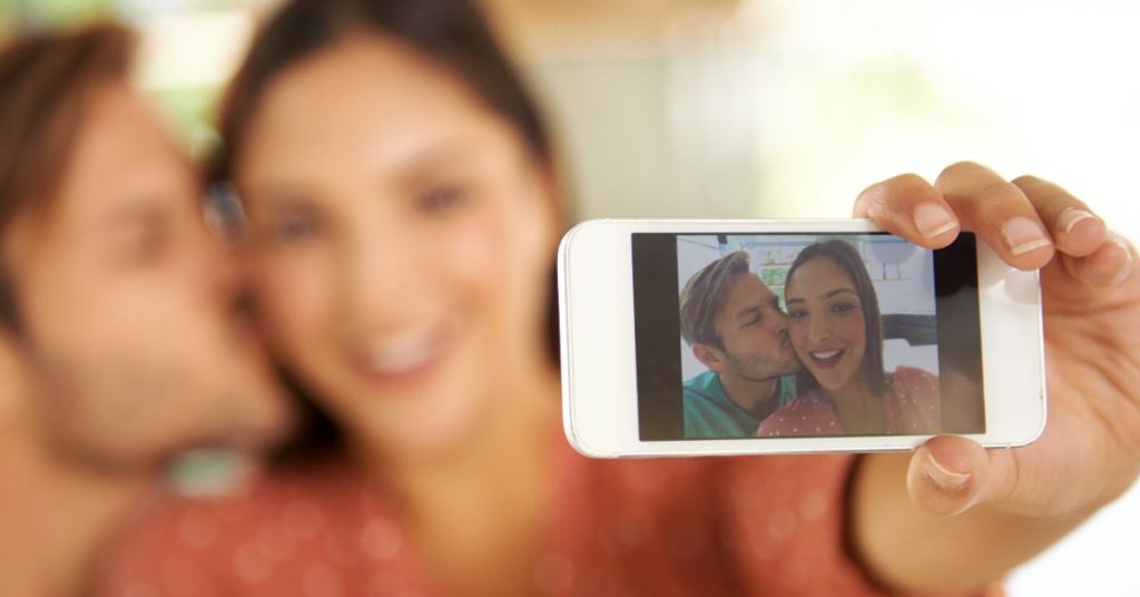 Couple taking a photo together with a cell phone