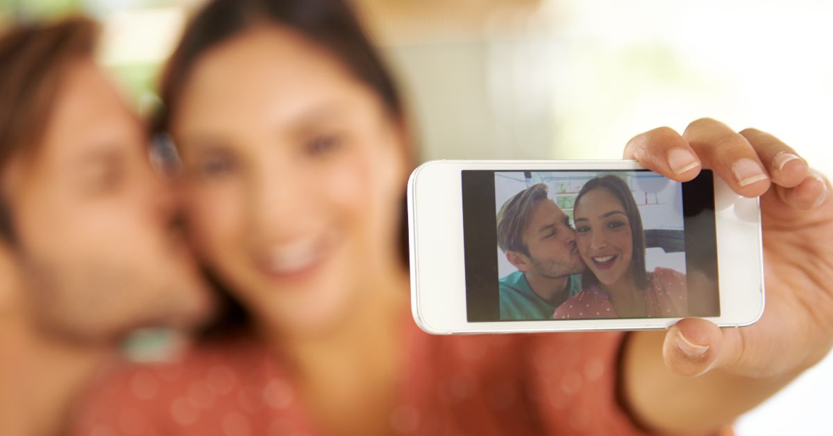 Couple taking a photo together with a cell phone