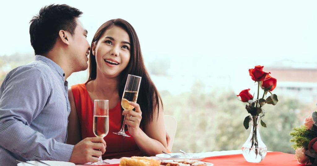 Question to as a woman | Man and woman sitting at a dining table and the man asking a question