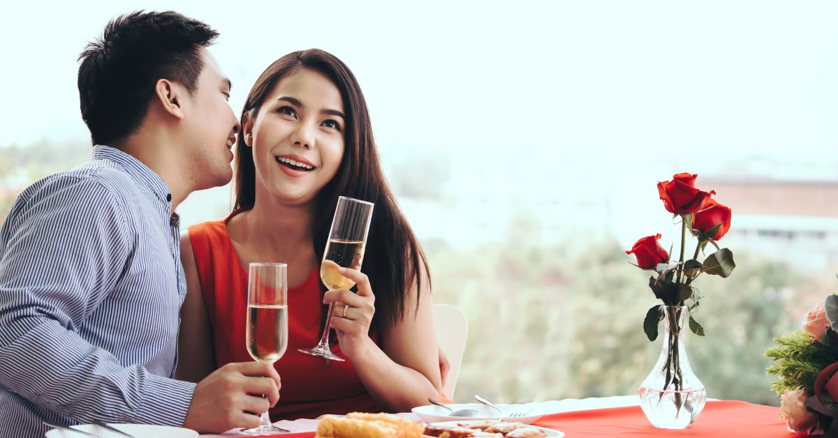 Question to as a woman | Man and woman sitting at a dining table and the man asking a question