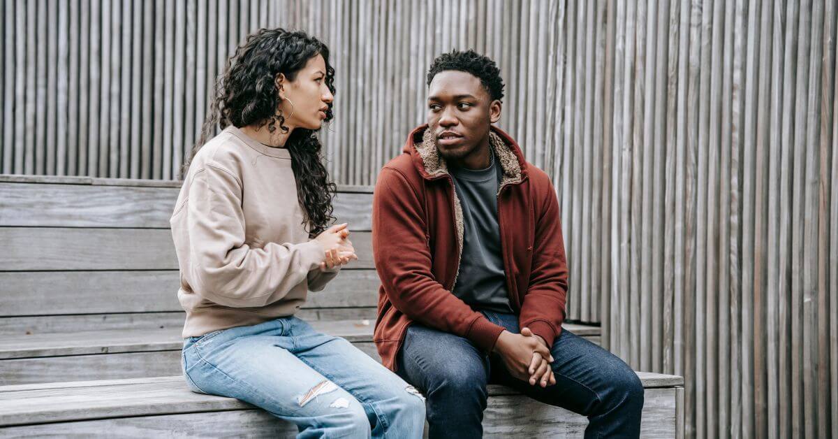 Make conversation easy | Couple sitting on a wooden bench and talking