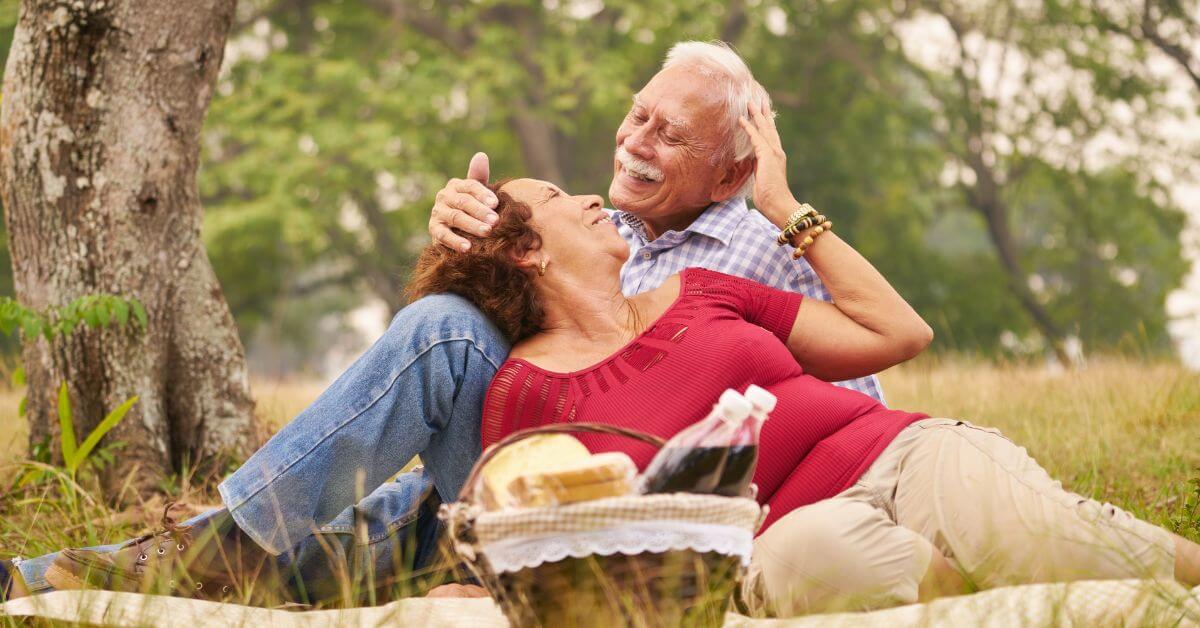 Perks of being in the "Over 50" Crowd | Image of an older couple having a picnic and enjoying each other's company
