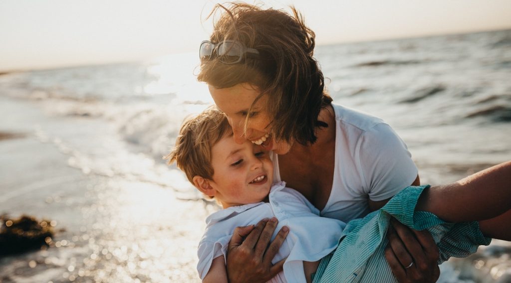 Single Mother on Beach with Child