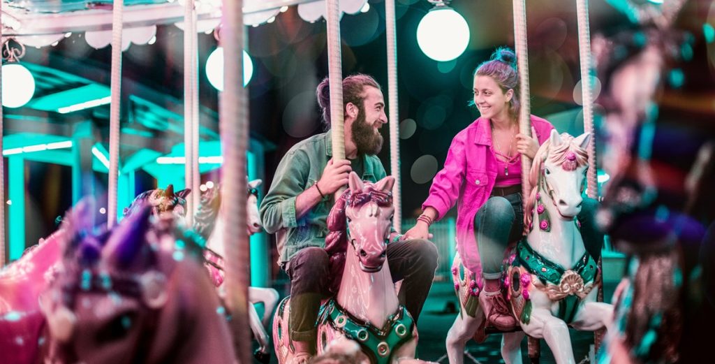 Couple Having Fun on Carousel
